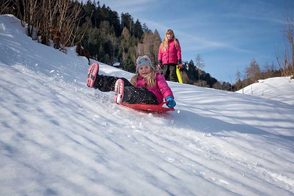 Children playing in snow at Alpine ski resort
