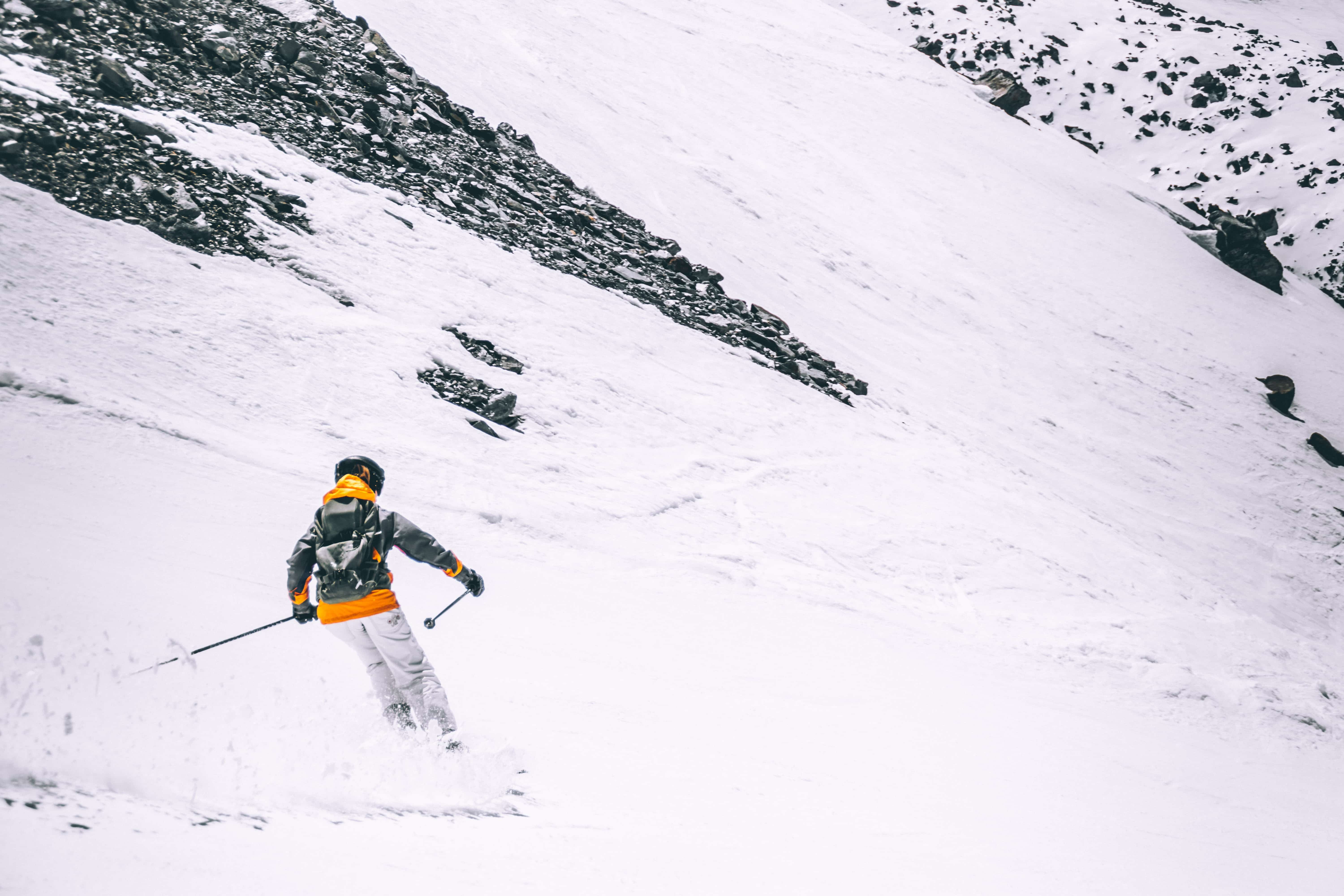 Skier wearing orange on mountain