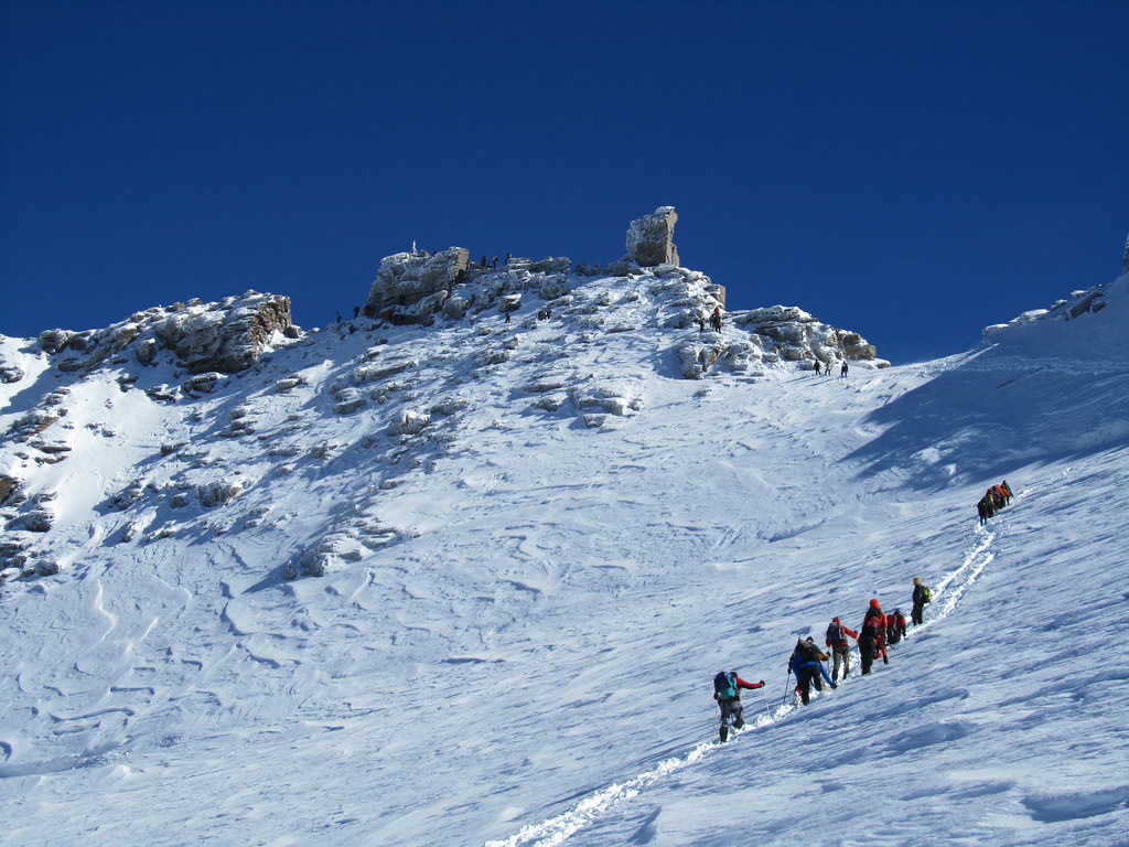 Hikers on a snowy mountain attempting the grand paradiso climb