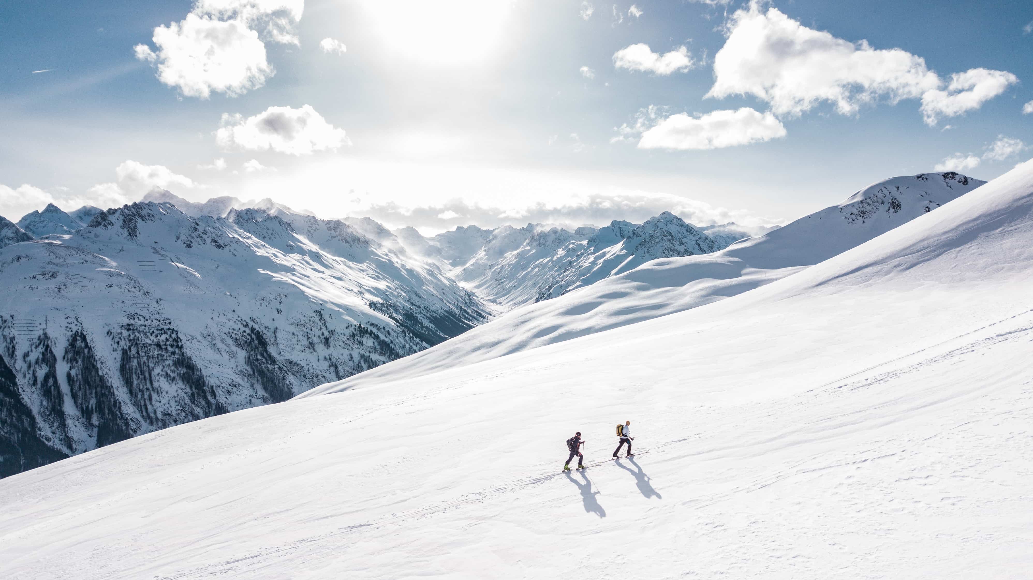 Two people ski mountaineering in the Alps
