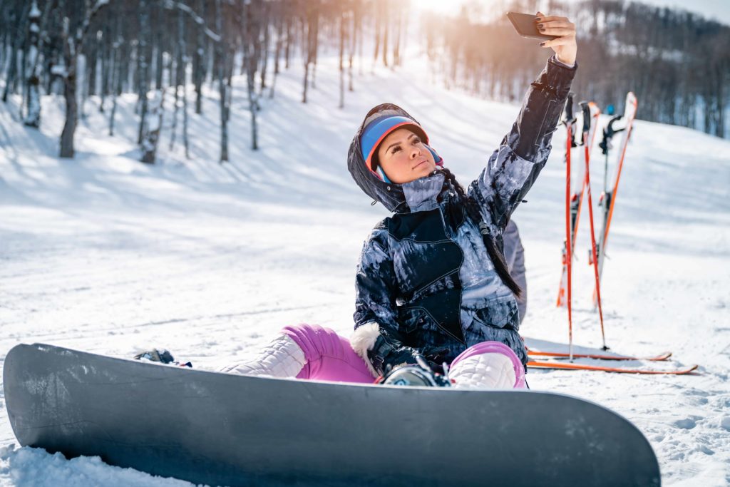 Snowboarder taking selfie on the mountain